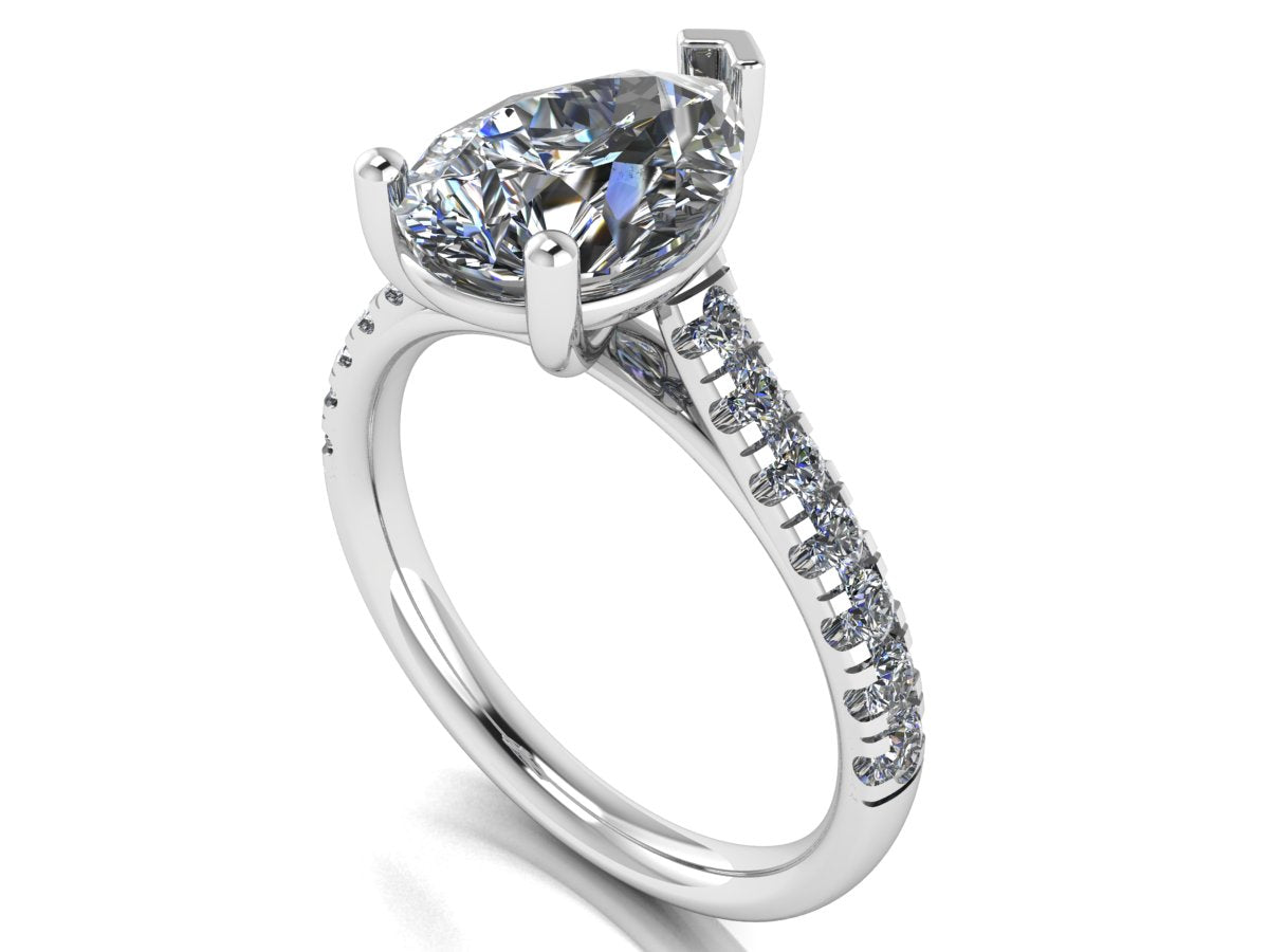 angled view of platinum or white gold pavé engagement ring with a pear shaped centre lab grown diamond and microset diamond shoulder
