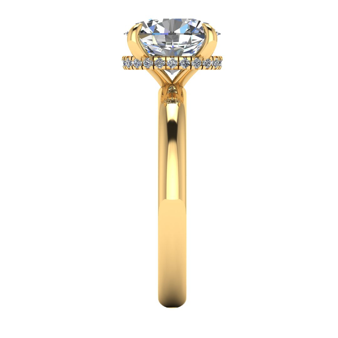 Side profile of a yellow gold engagement ring with a oval cut lab grown diamond with a secret hidden halo