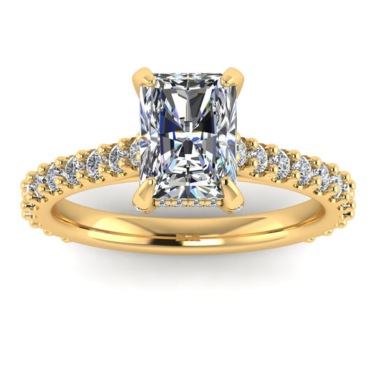 front view of Ellie yellow gold engagement ring which has a central emerald cut lab grown diamond, elegant under-halo, pavé-set shoulders, and delicate diamonds on the prongs for extra sparkle