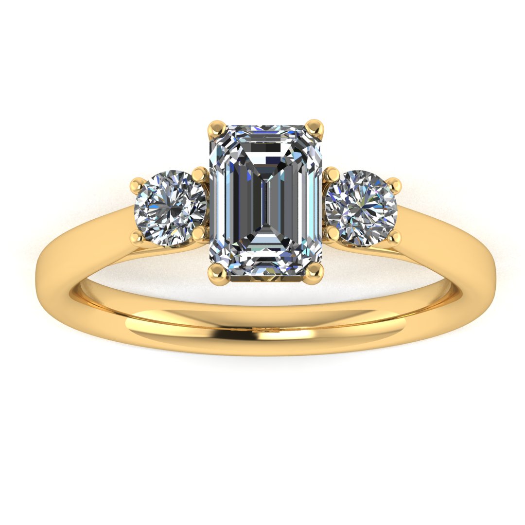 front view of a trilogy yellow gold engagement ring set with an emerald centre lab grown diamond with two round brilliant diamonds on either side of the centre stone