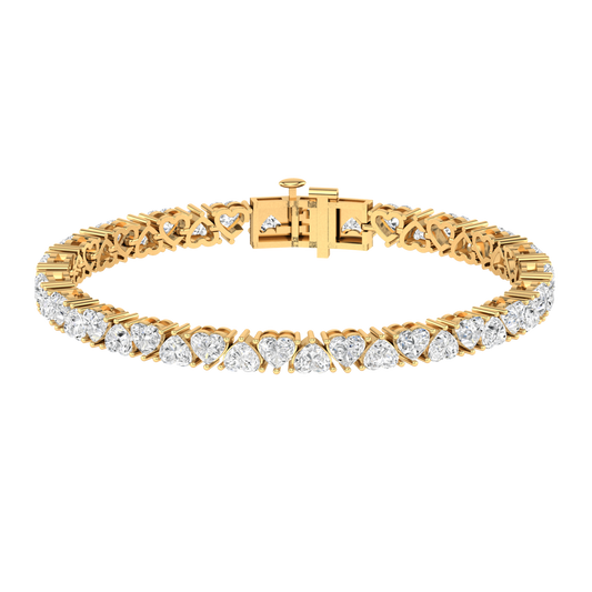 Yellow gold tennis bracelet with alternating heart shaped ethical & sustainable lab grown diamonds set using prongs