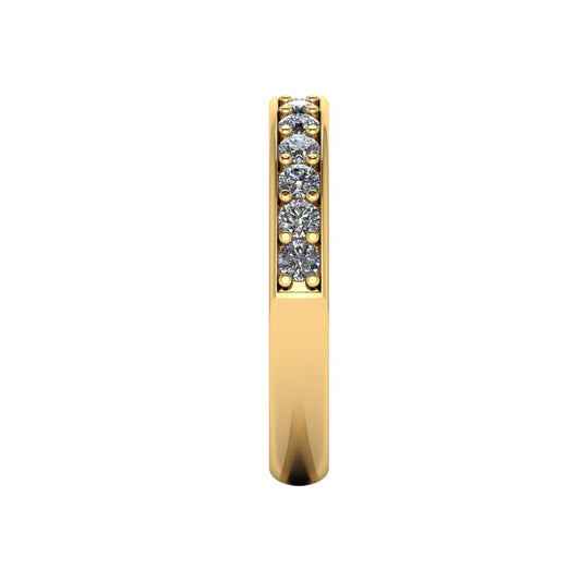 side view of a yellow gold eternity ring or wedding band with round brilliant lab-grown diamonds set in a fine grain setting