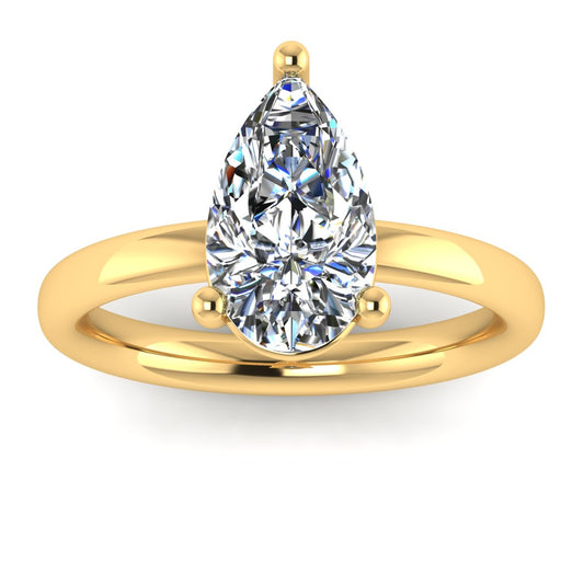 front view of a yellow gold engagement ring with a pear cut lab grown ethical and sustainable diamond