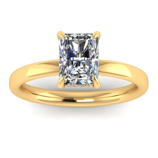 front view of a yellow gold single solitaire engagement with set with a radiant cut lab grown diamond featuring a secret hidden under halo
